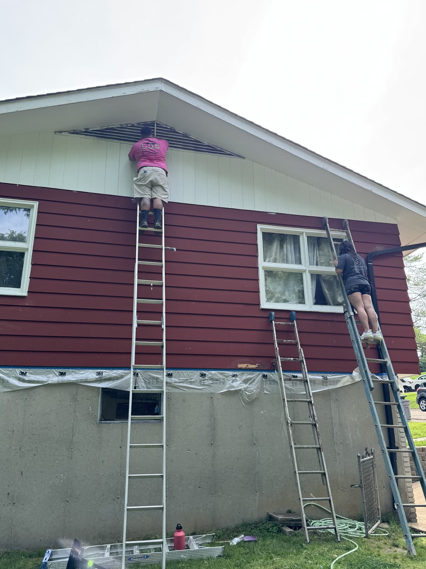 Exterior fascia and siding repair on a red-sided home