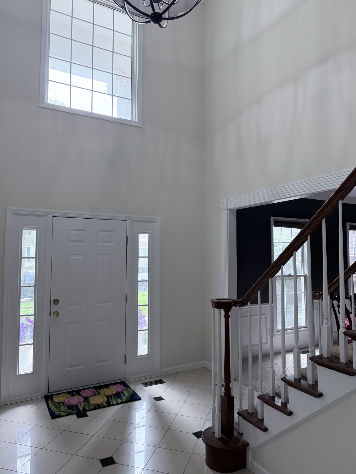 Freshly painted foyer with wood staircase and white walls