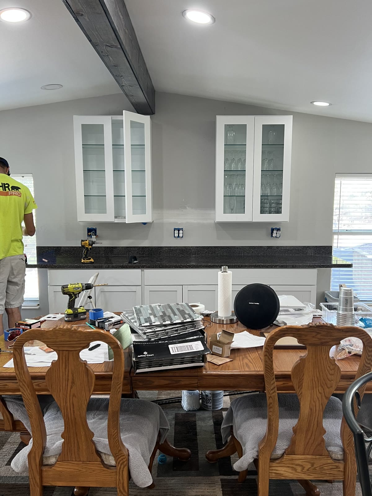 Kitchen remodel mid-install with new granite countertops and glass-front cabinets